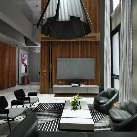 Double-height living room with a fluted wood-slat TV wall, black leather sofas and armchairs on a graphic black-and-white rug