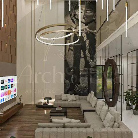 Double-height living room with a fluted wood TV wall, a tall carved stone deity relief panel, and a beige channel-tufted sectional under a ring pendant