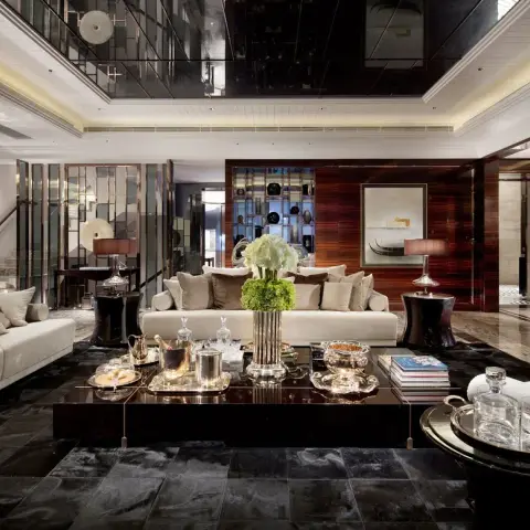 Double-height luxury living room with a glossy black mirrored ceiling, dark wood panelled walls