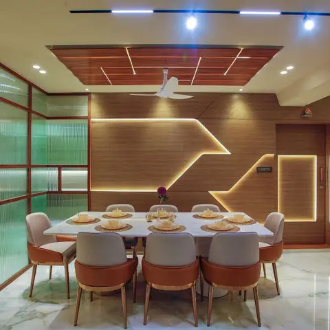 Eight-seater dining room with a wood-clad geometric-profile feature wall behind the table, a matching wood ceiling panel with linear lighting