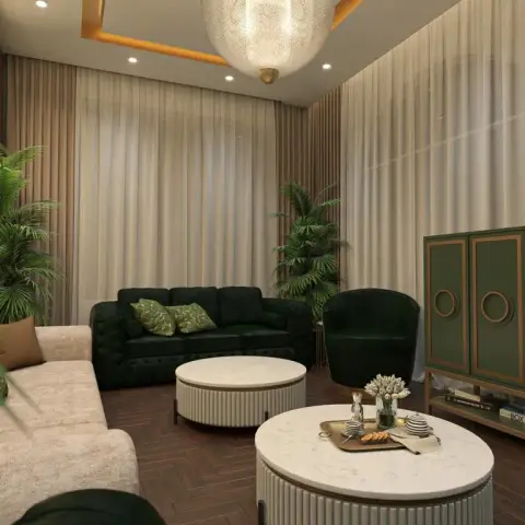 Emerald button-tufted sofa and swivel tub chair face two fluted-base round marble coffee tables on dark herringbone wood