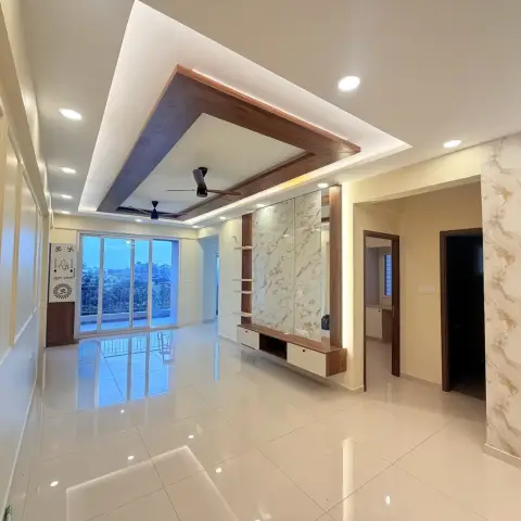 Empty flat living room with a mitred wood-framed dropped POP ceiling carrying two fans