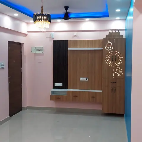 Empty living room entryway with a rose-pink and blue color-blocked wall, a blue LED cove ceiling, a crystal pendant light