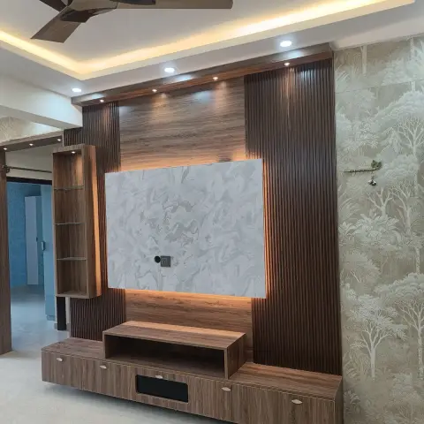 Empty living room whose walnut fluted TV wall frames a backlit grey marble-look panel