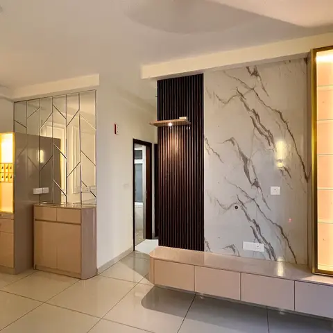 Empty living room with a dramatic veined-marble TV feature wall flanked by dark fluted wood panelling and a gold-trimmed backlit glass display niche