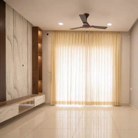 Empty living room with a marble-and-fluted-wood TV feature wall, a backlit floating console and floor-to-ceiling mustard curtains