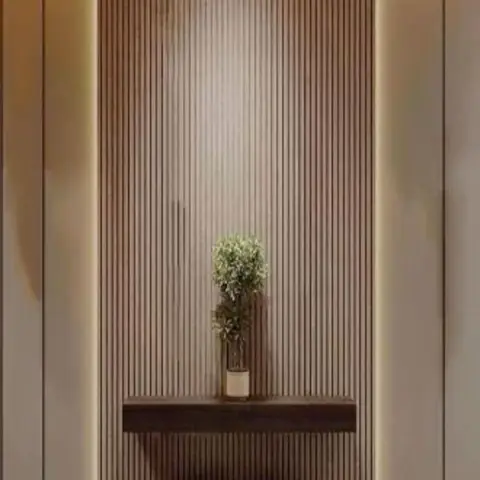 Entrance foyer with a backlit fluted wood-slat wall panel, a floating dark-wood console holding a single potted plant