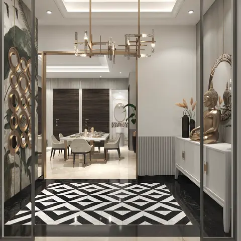 Entrance foyer with a bold black-and-white geometric marble floor medallion and a white console topped with a gold Buddha statue
