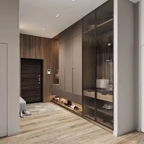 Entrance foyer with a dark wood-finish main door, wood-panelled feature wall, and a built-in shoe storage bench beneath a fluted-glass display cabinet