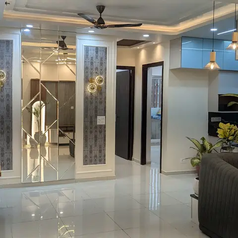 Entrance foyer with a diamond-cut mirror feature wall flanked by textured grey wallpaper panels