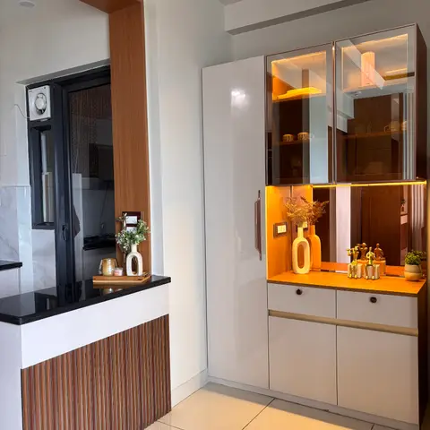 Entrance foyer with a glossy white and wood-toned crockery display unit featuring backlit glass upper cabinets