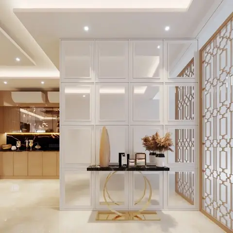 Entrance foyer with a mirrored grid-panel feature wall, a black marble-top console table on a gold ring base styled with a vase and pampas grass