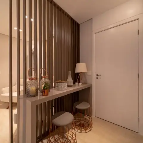 Entrance foyer with a vertical wood-slat partition screen, a narrow console table styled with lanterns and a table lamp