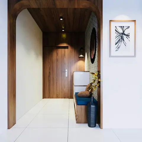 Entrance foyer with an arched wood-clad frame around the main door, a built-in shoe unit with a blue cushioned seat