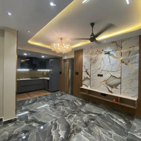 Entrance foyer with bold grey-and-gold veined marble flooring, a matching marble feature wall with cove lighting, and a crystal chandelier