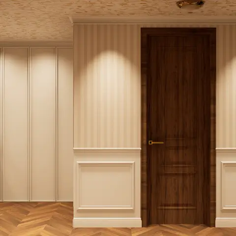 Entrance foyer with striped wallpaper above wainscot panel moulding, a dark wood-veneer door with brass handle, chevron parquet flooring