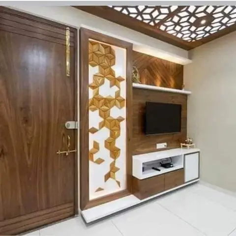 Entrance-living wall with a dark wood main door, a backlit 3D geometric wood panel beside it, a herringbone-panelled TV wall