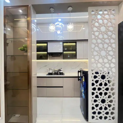Entry to a modular kitchen with marble-look backsplash, matte cabinets and a black chimney hood