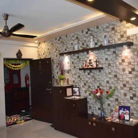 Entry with a chequered stone-mosaic wall, a stepped wenge display-and-storage unit holding family photographs and idols