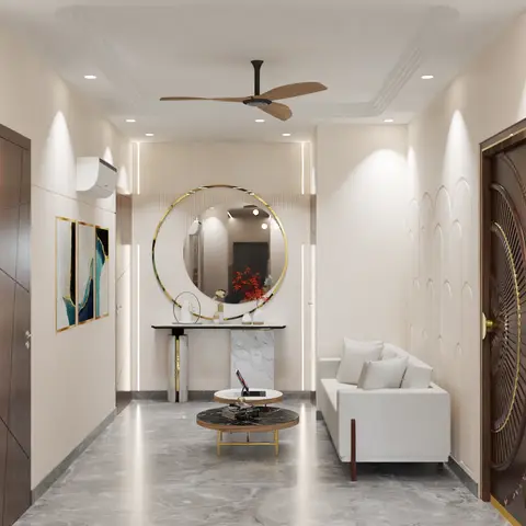 Entryway foyer with an ornate brass-ringed main door, a round gold-framed mirror over a marble console, and arched wall panelling leading into the living area.