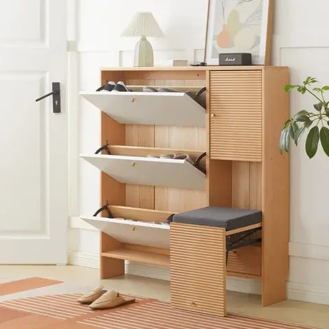 Entryway with a light oak fold-down shoe cabinet and a fold-out bench seat, styled with a table lamp, framed print