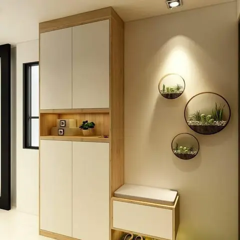 Entryway with a tall wood-and-white shoe cabinet with an integrated cushioned bench