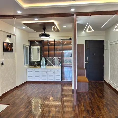 Entryway with walnut-tone herringbone-style wood flooring, a black panelled main door, a slatted-door shoe unit under a backlit mirror