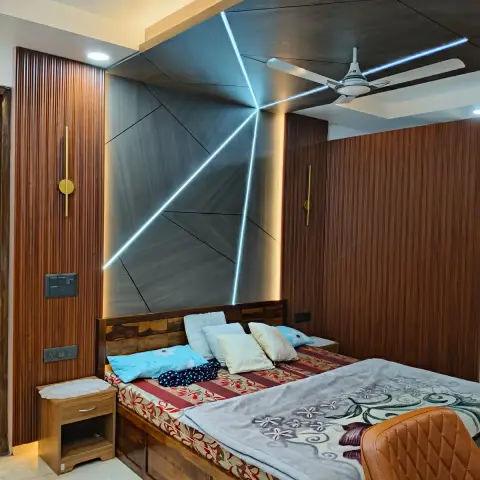 Faceted grey headboard panel cut by radiating cool-white LED lines, framed by fluted teak cladding on both side walls and a matching wood ceiling drop