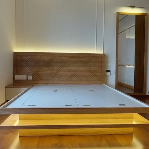 Floating platform bed with a backlit diamond-lattice wood headboard and a full-length wood-framed mirror, mattress not yet installed