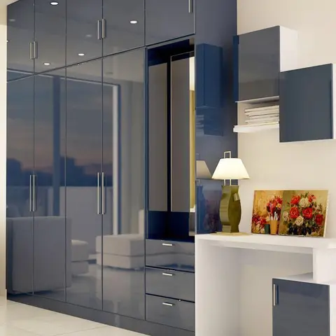 Floor-to-ceiling navy high-gloss wardrobe with a full-length mirror strip, adjoining a white study desk with a wall-mounted display shelf.