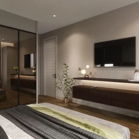 Foot-of-bed view across a beige bedroom to a full-height bronze-mirror sliding wardrobe and a long wenge drawer console under a backlit stone ledge carrying