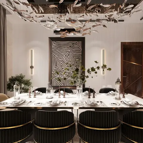 Formal dining room with a dramatic school-of-fish sculptural chandelier, black channel-tufted chairs with brass trim