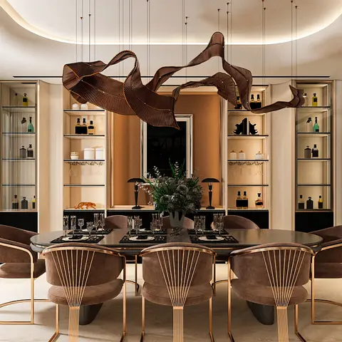 Formal dining room with a sculptural ribbon pendant light over an oval table, brass-trimmed velvet chairs, and backlit glass display cabinets flanking the wall.