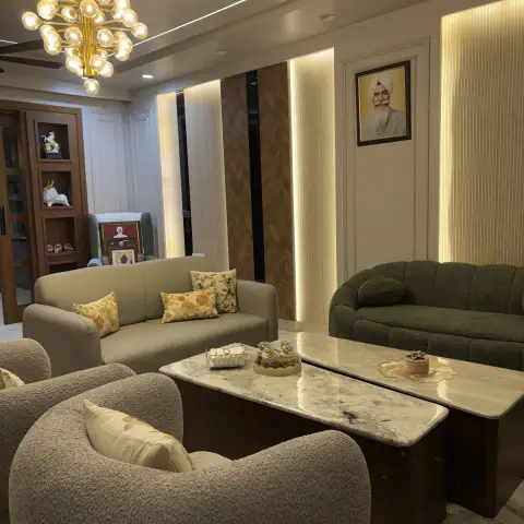 Formal drawing room with an olive boucle sofa facing a beige leatherette one, two curved boucle tub chairs, twin marble-top tables