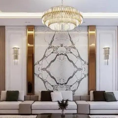 Formal living room where a book-matched grey-veined marble slab wall is centred under a multi-tier crystal drum chandelier, flanked by fluted veneer panels