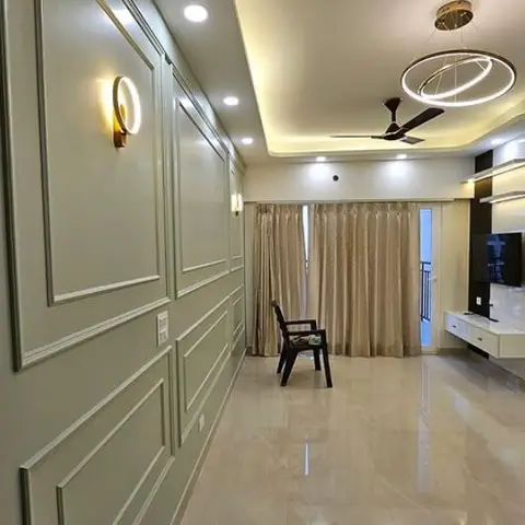 Foyer-to-living hallway lined with sage-green raised wall panelling and a wall sconce