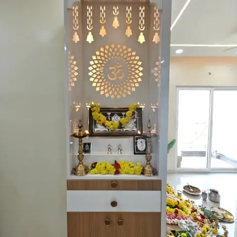 Freestanding pooja unit with a temple-arch top: backlit CNC-cut hanging bells and an Om mandala in white