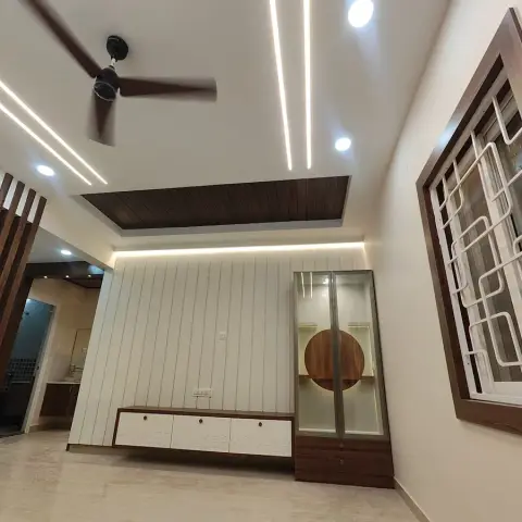 Freshly finished and still unfurnished hall with a white fluted TV wall, a floating white-and-walnut console