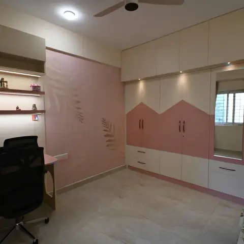 Girl's bedroom in cream and dusty pink: wardrobe shutters split by a zigzag colour line, a mirrored dressing panel framing the window inside the same run