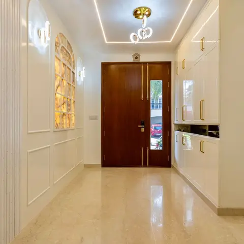 Grand entrance foyer with a wooden double main door, backlit onyx wall panel, fluted wall cladding