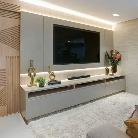 Greige TV wall with the screen recessed into a flush panel, LED strips washing the ceiling above and the console below