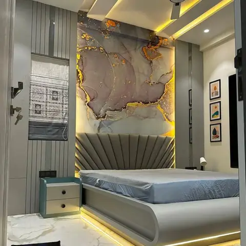 Grey fan-pleated headboard under a backlit pink-and-gold alcohol-ink mural panel, on a floating bed base with an under-bed LED glow and a stepped cove ceiling