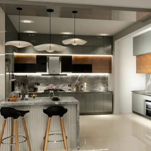 Grey gloss kitchen with amber back-painted glass wall units, a fluted-base peninsula in grey marble and three wavy white pendants over two black bar stools