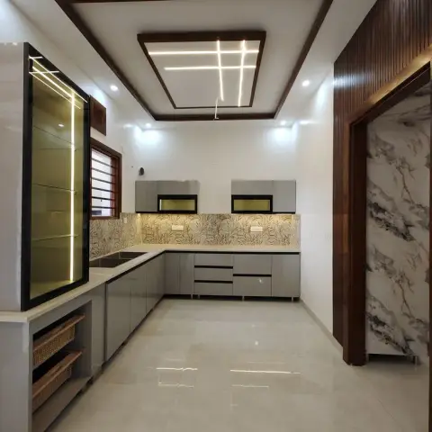 Grey L-shaped modular kitchen with a printed botanical dado, LED-lit niches under the wall units and a cross-shaped light profile in a walnut-framed false