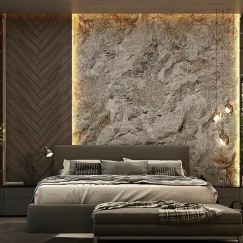 Grey upholstered bed against a backlit rough stone slab panel, flanked by dark herringbone wood cladding and a diamond-mullion mirror wall