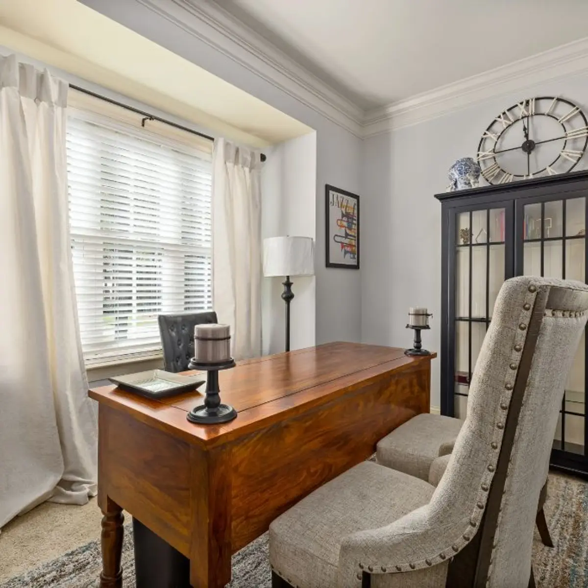 Home office nook with antique writing desk and upholstered chair