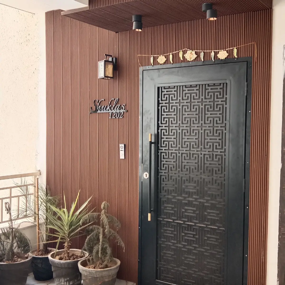 earthy modern indian entrance foyer with cladding — real Indian home