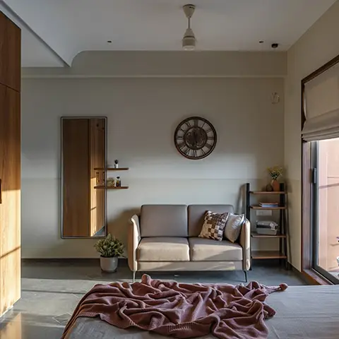 Bedroom with walnut wardrobe, loveseat, full-length mirror and balcony access