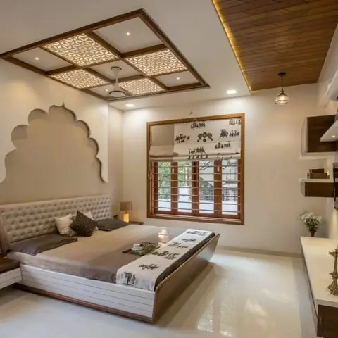 Bedroom with a backlit jaali-pattern false ceiling framed in wood panelling