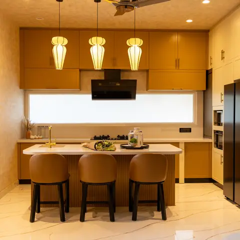 Mustard-cabinet kitchen island with three lantern pendant lights